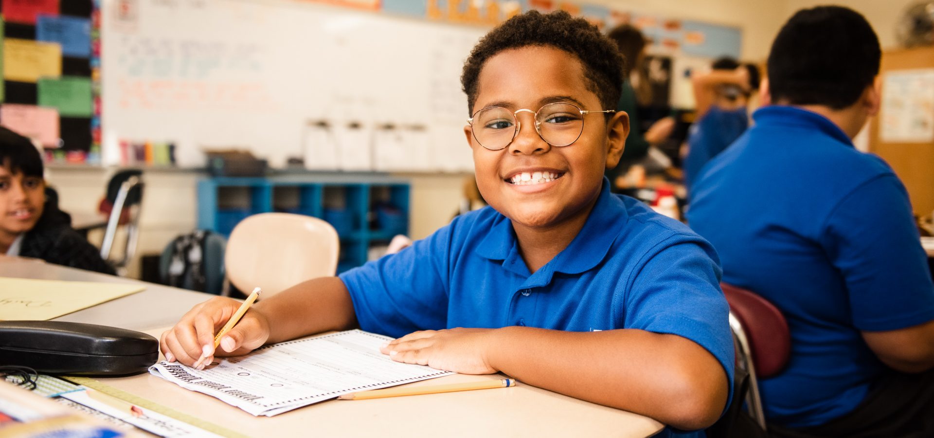 Child writing at a desk