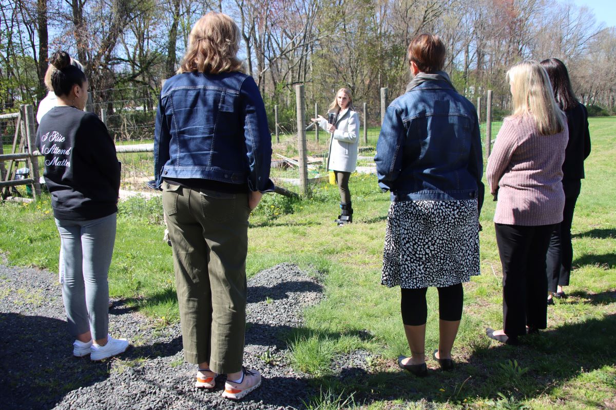 a ground of people stand around a school garden